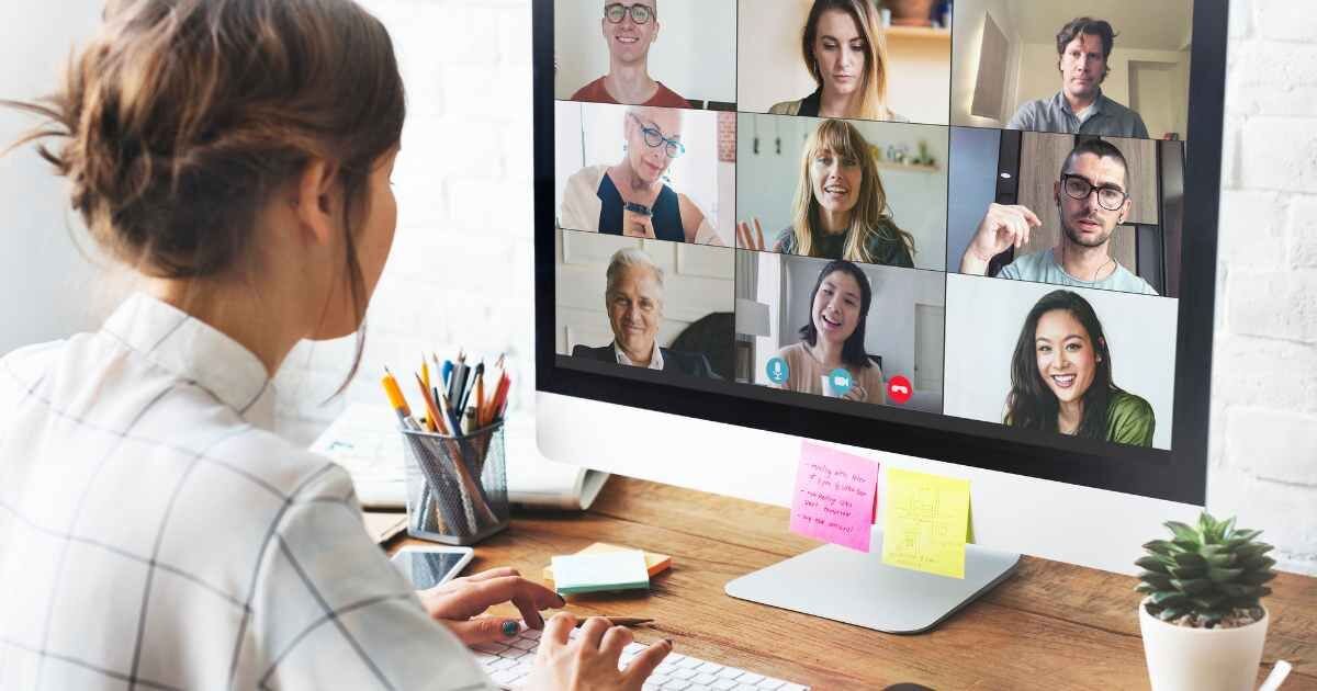 Woman participating in a video conference call on her computer from a home office